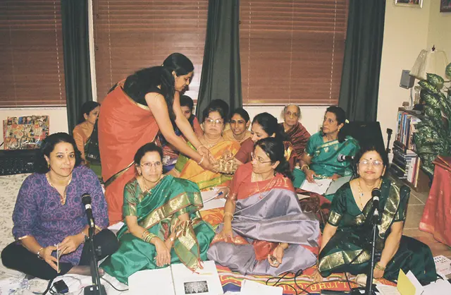 Lalitha Alladi offering manjal and kumkum to the Prarthana Group. L to R: Uma Iyer, Sarala Samakur, Mira Sankar, Sandhya Devalaraju, Uma Sathuram (font), Raji Narayan (rear), Kalpakam Mami, Lalitha Ganesh, Mathura Alladi